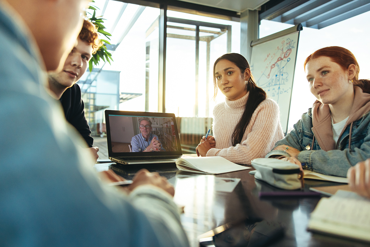 Zwei junge Frauen in einem Meeting mit Onlinebeteiligung
